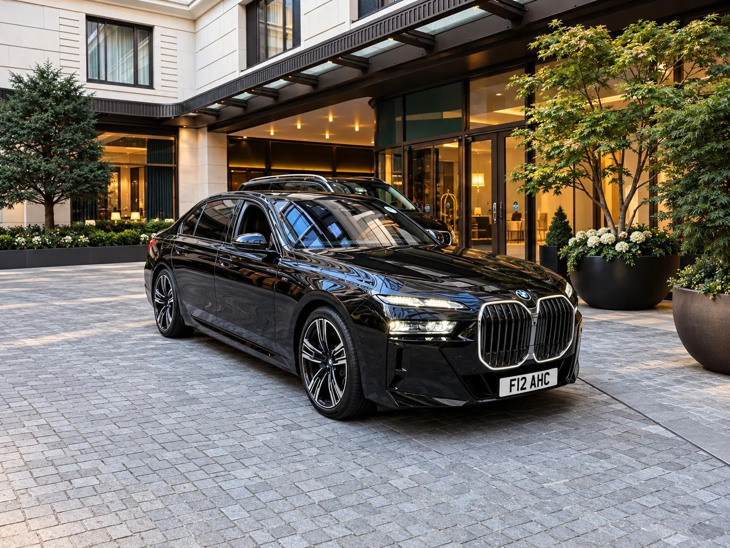 BMW 7 Series with AHC registration outside a London hotel