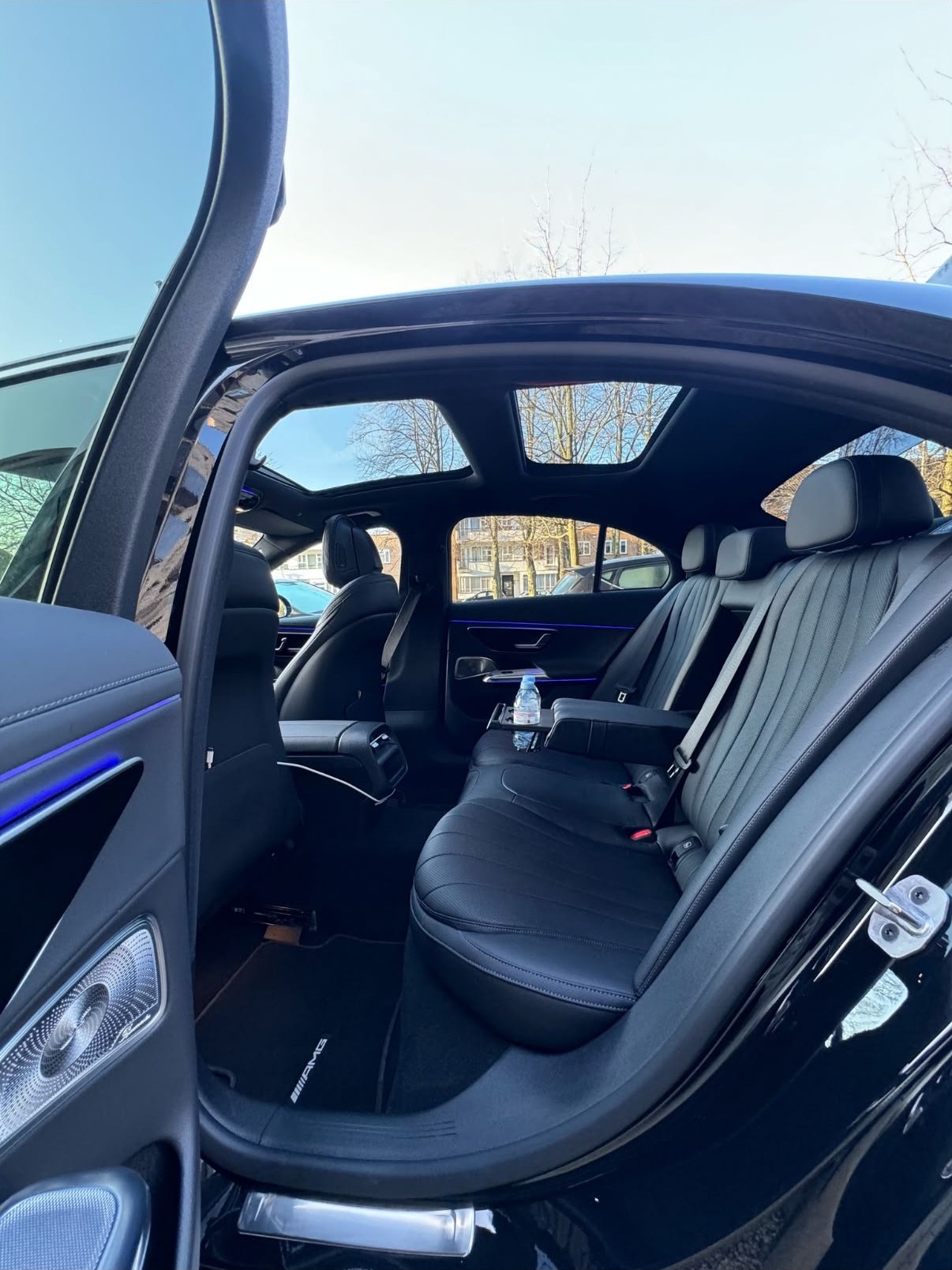 Open rear door showing the black leather cabin of the Halcolux E-Class