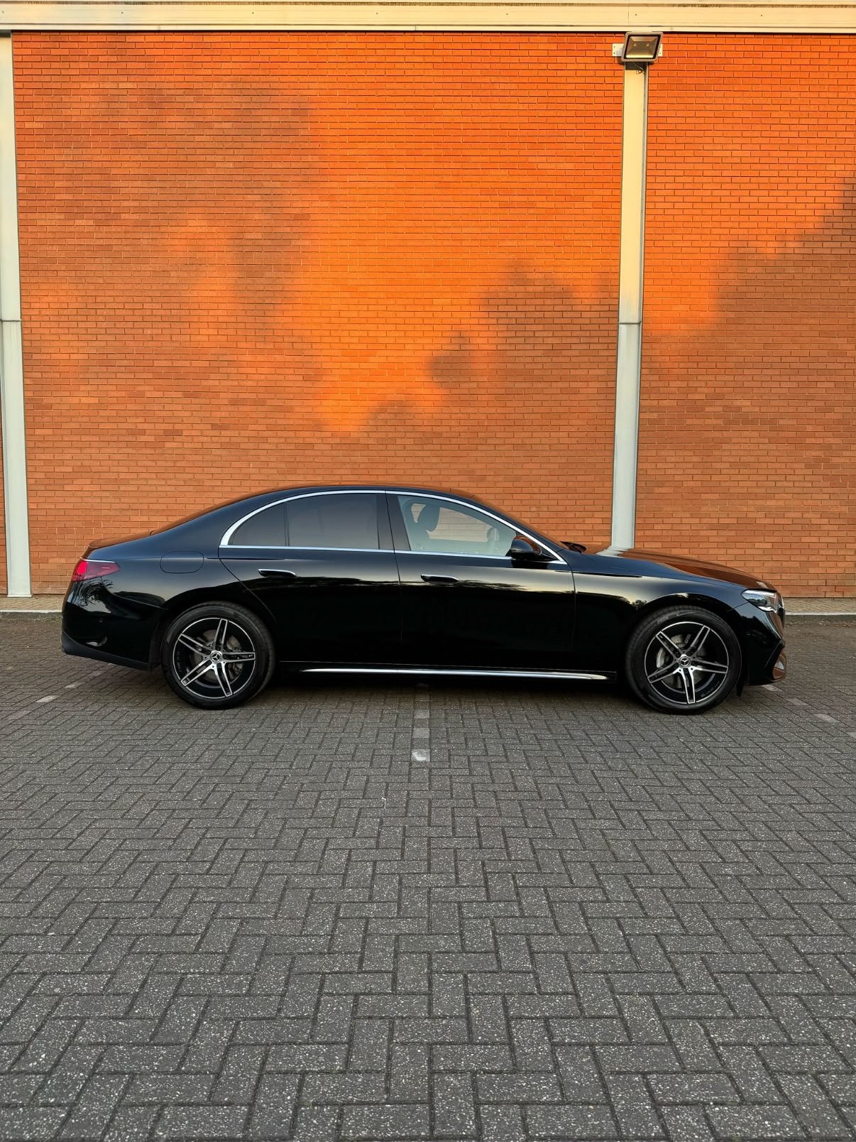 Side profile of a black Halcolux Mercedes-Benz E-Class